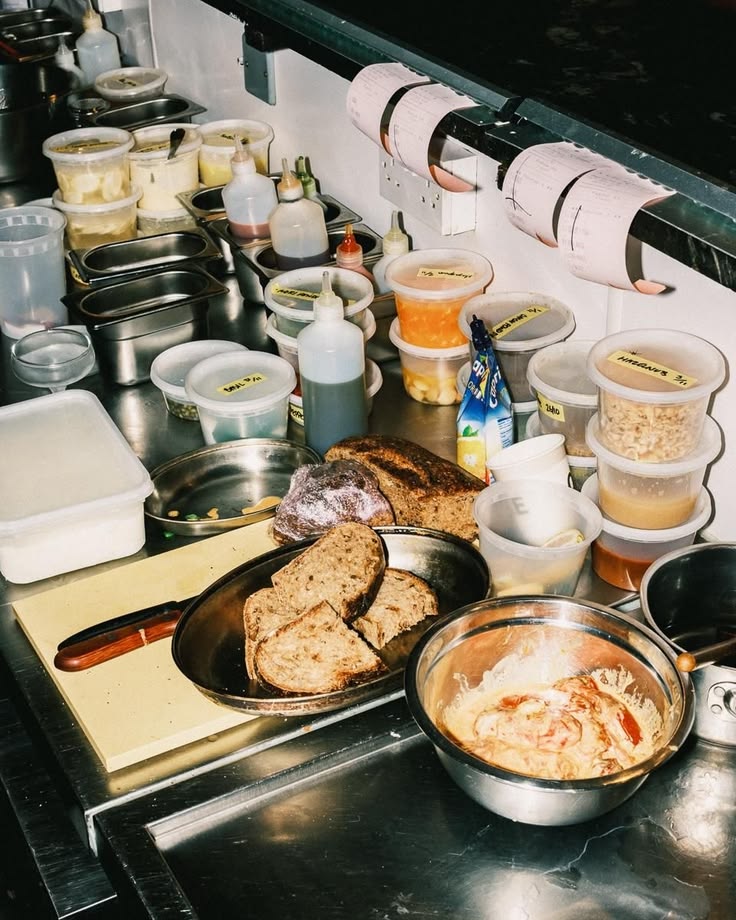 Kitchen prep station with labelled containers and bread